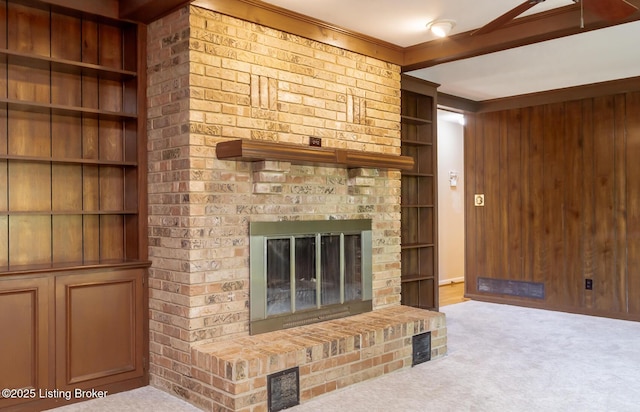 606 N Arbor Dr, Louisville, KY 40223 - unfurnished living room with carpet floors, a fireplace, built in features, and wooden walls