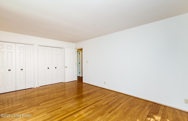 606 N Arbor Dr, Louisville, KY 40223 - unfurnished bedroom with two closets and light wood-style flooring