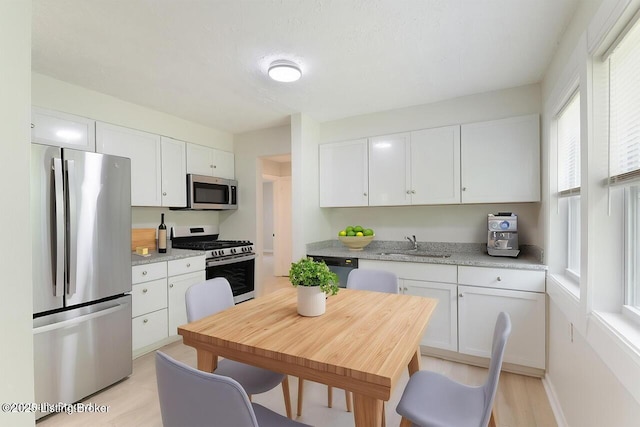1215 Vim Dr, Louisville, KY 40213 - kitchen with appliances with stainless steel finishes and white cabinetry