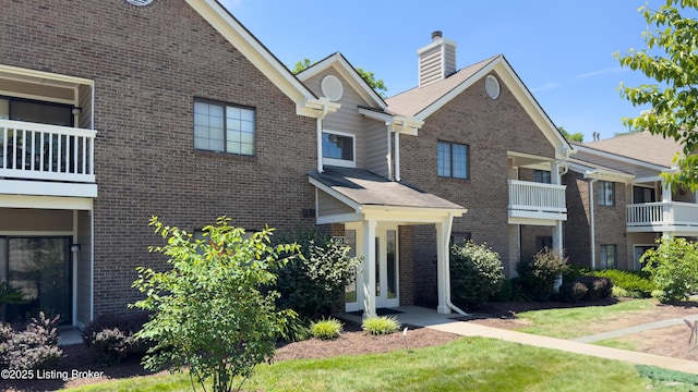 410 Ethridge Ave Unit 103, Louisville, KY 40223 - view of front of house featuring brick siding and a chimney