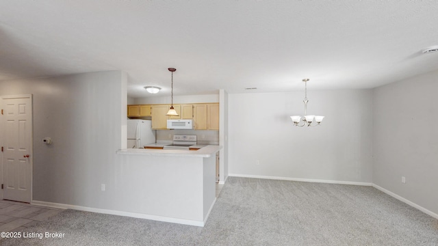 410 Ethridge Ave Unit 103, Louisville, KY 40223 - kitchen with white appliances, a chandelier, light countertops, light brown cabinets, and pendant lighting