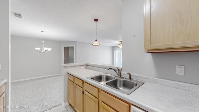 410 Ethridge Ave Unit 103, Louisville, KY 40223 - kitchen with light brown cabinets, light countertops, pendant lighting, and a chandelier