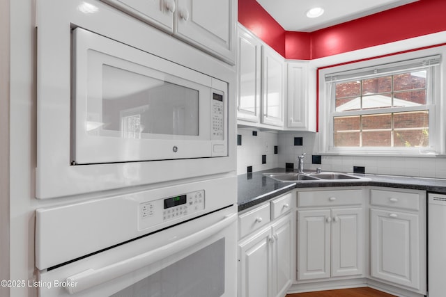 3012 Hayfield Dr, Louisville, KY 40205 - kitchen with white appliances, white cabinetry, dark countertops, and tasteful backsplash