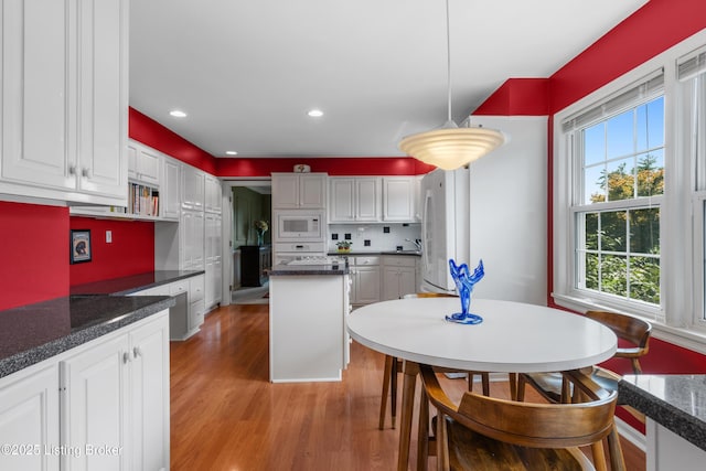 3012 Hayfield Dr, Louisville, KY 40205 - kitchen with white appliances, light wood-style floors, white cabinets, a kitchen island, and recessed lighting