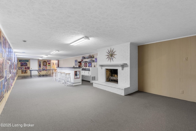 3012 Hayfield Dr, Louisville, KY 40205 - recreation room featuring a community bar, a textured ceiling, carpet flooring, and a brick fireplace
