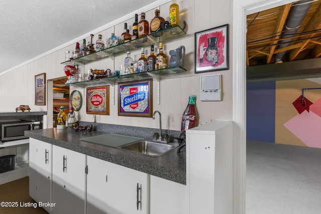 3012 Hayfield Dr, Louisville, KY 40205 - indoor wet bar featuring stainless steel microwave, a textured ceiling, and ornamental molding