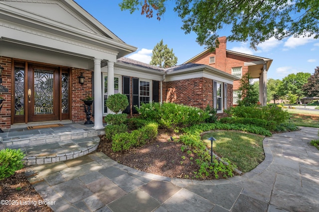3012 Hayfield Dr, Louisville, KY 40205 - doorway to property with brick siding, a chimney, and a porch