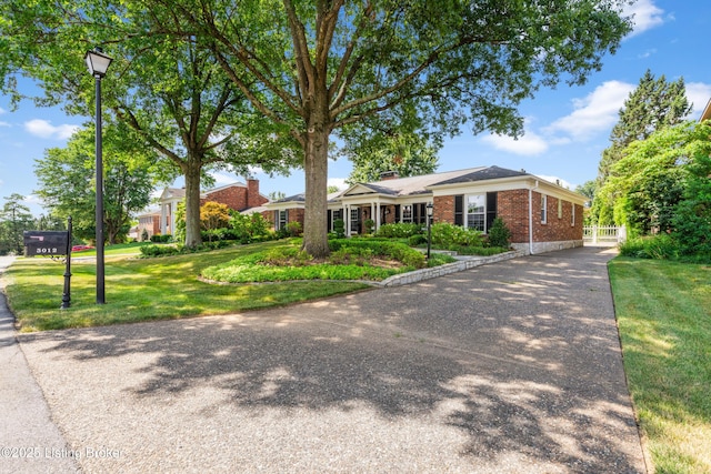 3012 Hayfield Dr, Louisville, KY 40205 - ranch-style house with brick siding, a front lawn, and driveway