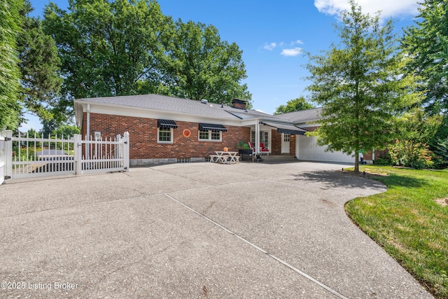 3012 Hayfield Dr, Louisville, KY 40205 - view of front of property with brick siding, a gate, and a chimney