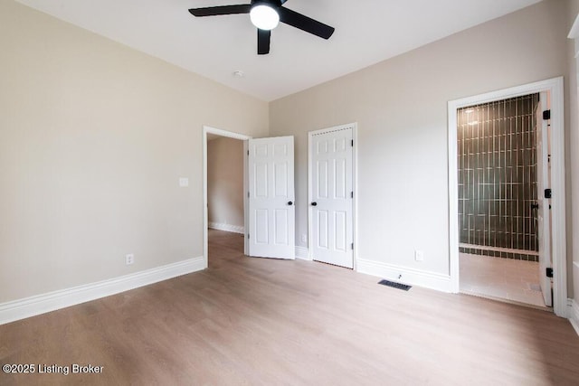 412 Gwendolyn St, Louisville, KY 40203 - unfurnished bedroom featuring wood finished floors and connected bathroom