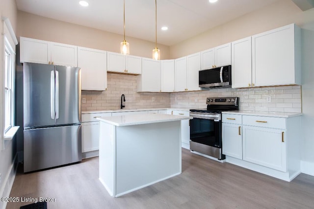 412 Gwendolyn St, Louisville, KY 40203 - kitchen with appliances with stainless steel finishes, light wood-style floors, light countertops, tasteful backsplash, and recessed lighting