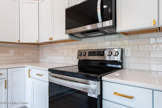 412 Gwendolyn St, Louisville, KY 40203 - kitchen featuring appliances with stainless steel finishes, white cabinets, tasteful backsplash, and light stone countertops