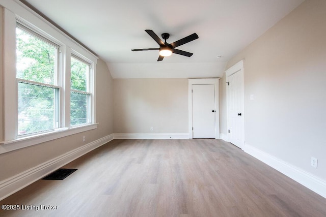 412 Gwendolyn St, Louisville, KY 40203 - empty room featuring light wood finished floors, a ceiling fan, and vaulted ceiling