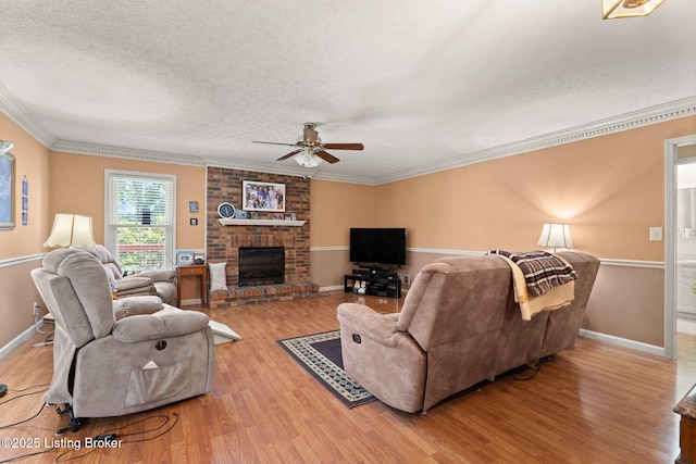 3941 Scenic Trl, Shepherdsville, KY 40165 - living room featuring a textured ceiling, a ceiling fan, wood finished floors, ornamental molding, and a fireplace
