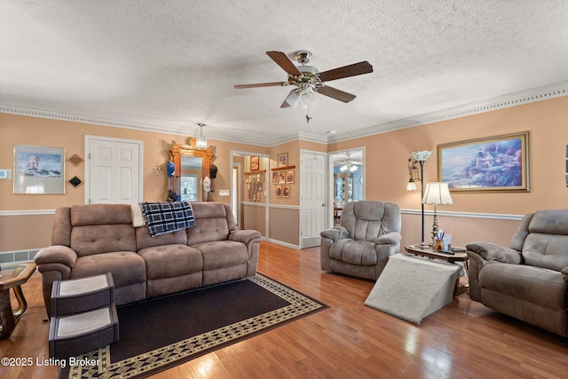 3941 Scenic Trl, Shepherdsville, KY 40165 - living room with ceiling fan, a textured ceiling, wood finished floors, and ornamental molding
