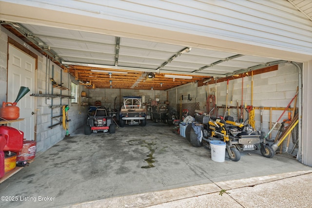 3941 Scenic Trl, Shepherdsville, KY 40165 - garage featuring concrete block wall and a garage door opener