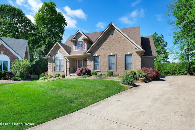 7728 Cottage Cove Way, Louisville, KY 40214 - view of front of home with brick siding, a front yard, roof with shingles, and driveway