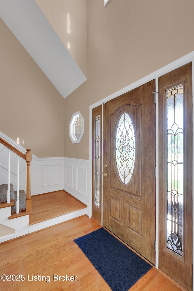 7728 Cottage Cove Way, Louisville, KY 40214 - entryway featuring a wainscoted wall, wood finished floors, a decorative wall, and stairway