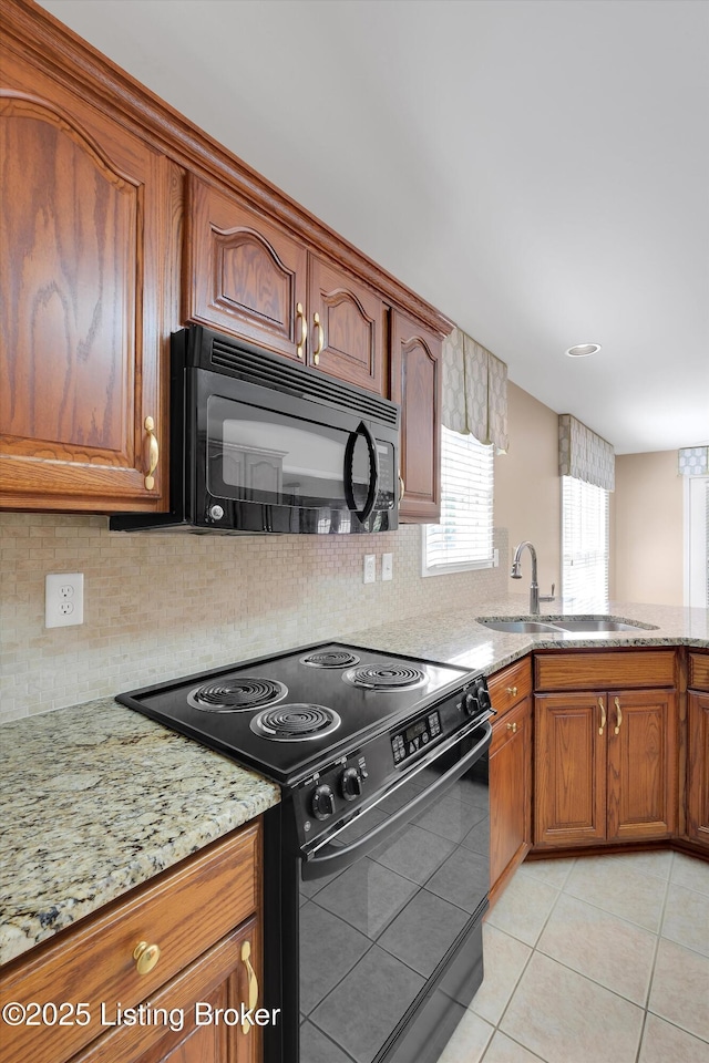 7728 Cottage Cove Way, Louisville, KY 40214 - kitchen featuring black appliances, light stone counters, light tile patterned floors, brown cabinets, and backsplash