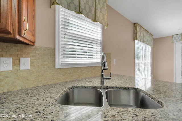 7728 Cottage Cove Way, Louisville, KY 40214 - kitchen view of decorative backsplash, brown cabinets, and light stone countertops