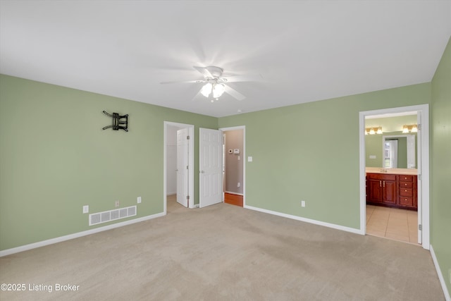 7728 Cottage Cove Way, Louisville, KY 40214 - unfurnished bedroom featuring light colored carpet, a spacious closet, connected bathroom, a closet, and ceiling fan