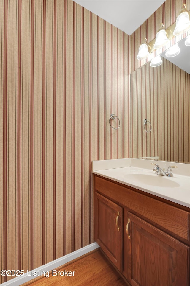 7728 Cottage Cove Way, Louisville, KY 40214 - bathroom featuring vanity, wood finished floors, and wallpapered walls