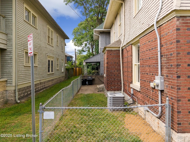 1246 Ormsby Ct, Louisville, KY 40203 - view of side of property with a gazebo, a fenced backyard, and brick siding