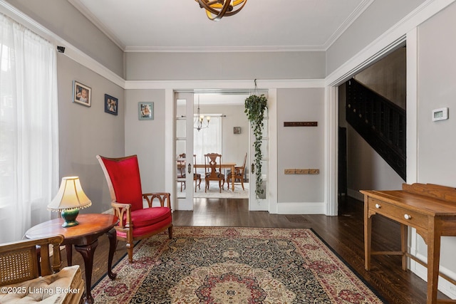 1246 Ormsby Ct, Louisville, KY 40203 - living area with a chandelier, wood finished floors, and ornamental molding