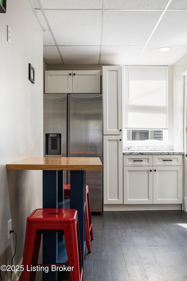 1246 Ormsby Ct, Louisville, KY 40203 - kitchen with stainless steel refrigerator with ice dispenser, a paneled ceiling, wooden counters, and white cabinets