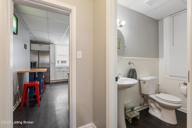1246 Ormsby Ct, Louisville, KY 40203 - bathroom featuring a paneled ceiling, wood finished floors, and a wainscoted wall