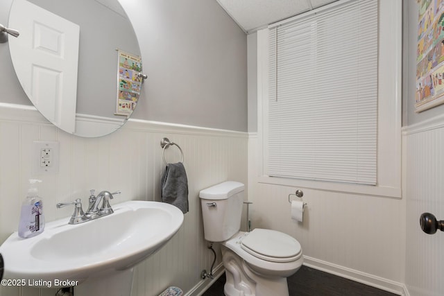 1246 Ormsby Ct, Louisville, KY 40203 - bathroom featuring a wainscoted wall and wood finished floors
