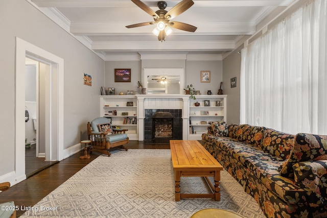1246 Ormsby Ct, Louisville, KY 40203 - living area featuring wood finished floors, ceiling fan, a tiled fireplace, beamed ceiling, and crown molding