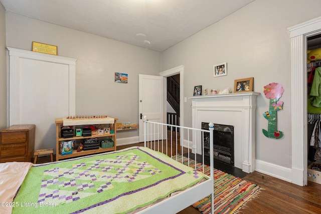 1246 Ormsby Ct, Louisville, KY 40203 - bedroom featuring wood finished floors and a fireplace with flush hearth