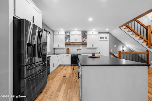 422 Lilac Ln, Cub Run, KY 42729 - kitchen featuring appliances with stainless steel finishes, dark countertops, open shelves, light wood-style floors, and white cabinetry
