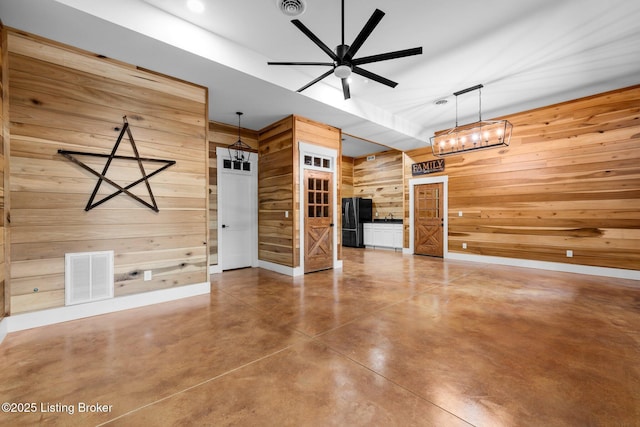 422 Lilac Ln, Cub Run, KY 42729 - unfurnished living room featuring wood walls, concrete floors, and a ceiling fan