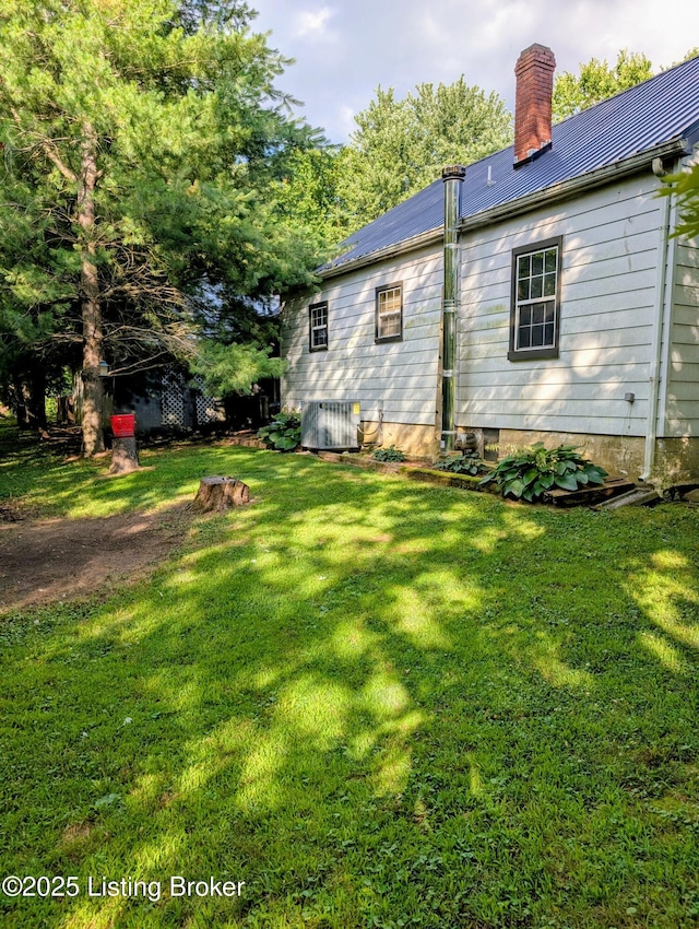 118 Hardin Spring Rd, Big Clifty, KY 42712 - back of house featuring a chimney, a metal roof, and a lawn