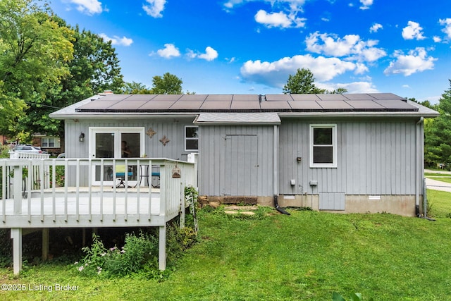 6818 Village Green Blvd, Pewee Valley, KY 40056 - back of property featuring a yard, a wooden deck, roof mounted solar panels, and board and batten siding