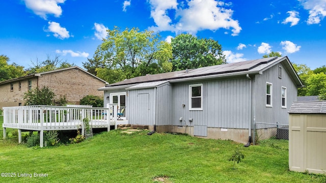 6818 Village Green Blvd, Pewee Valley, KY 40056 - back of house with a deck, a yard, roof mounted solar panels, a storage shed, and a shingled roof