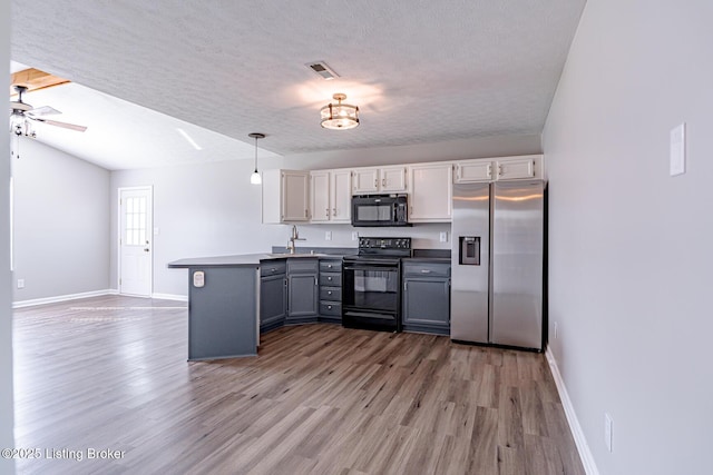 372 Wild Way, Louisville, KY 40229 - kitchen featuring black appliances, a peninsula, light wood-style flooring, a textured ceiling, and gray cabinetry