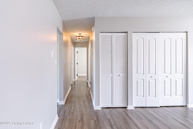 372 Wild Way, Louisville, KY 40229 - corridor with wood finished floors, a textured ceiling, and a chandelier