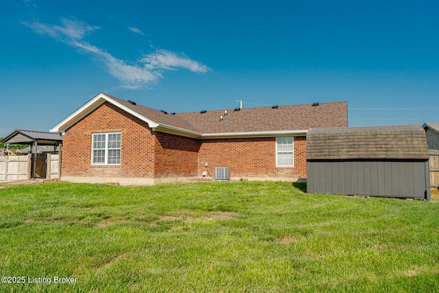 372 Wild Way, Louisville, KY 40229 - back of property featuring a shed, brick siding, and roof with shingles