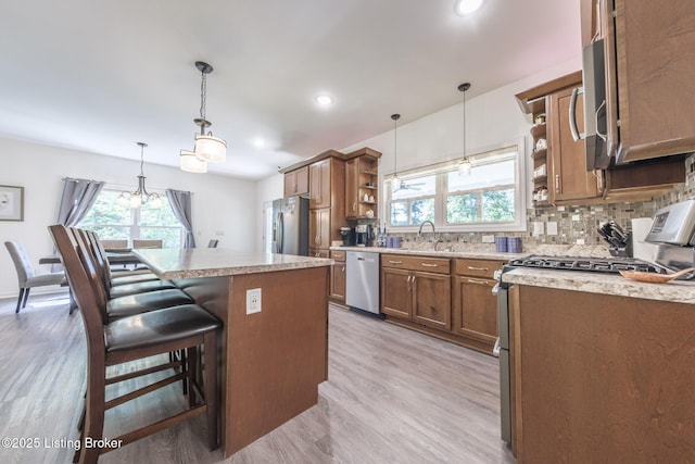 164 Greenshores Circle Ln, Mcdaniels, KY 40152 - kitchen featuring open shelves, appliances with stainless steel finishes, light wood finished floors, decorative backsplash, and a kitchen island