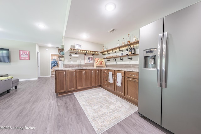 164 Greenshores Circle Ln, Mcdaniels, KY 40152 - kitchen with stainless steel fridge, open shelves, brown cabinets, light wood-style flooring, and recessed lighting