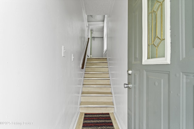 1373 Cypress St, Louisville, KY 40211 - stairs featuring a textured ceiling and baseboards