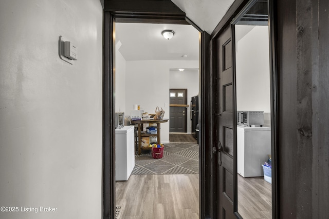 1373 Cypress St, Louisville, KY 40211 - hall with light wood-type flooring and washer / clothes dryer
