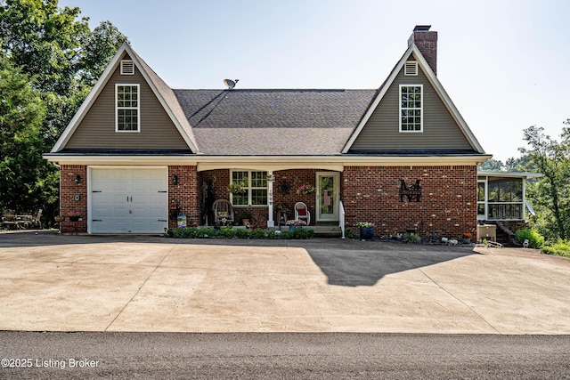 309 Clarks Ln, Clarkson, KY 42726 - traditional home featuring a chimney, brick siding, a garage, a sunroom, and concrete driveway
