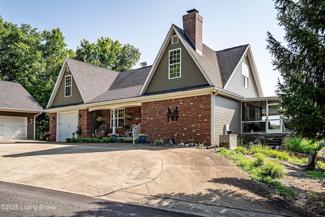 309 Clarks Ln, Clarkson, KY 42726 - traditional home featuring a chimney, driveway, brick siding, and a garage