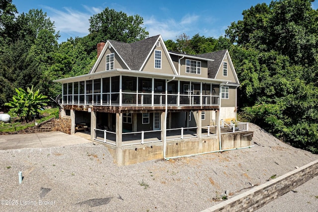 309 Clarks Ln, Clarkson, KY 42726 - view of front facade featuring a sunroom, a chimney, and roof with shingles