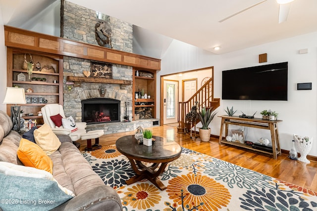 309 Clarks Ln, Clarkson, KY 42726 - living area with light wood-type flooring, vaulted ceiling, built in features, a ceiling fan, and a stone fireplace