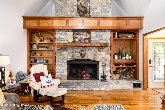 309 Clarks Ln, Clarkson, KY 42726 - living area with wood finished floors, a stone fireplace, and built in shelves
